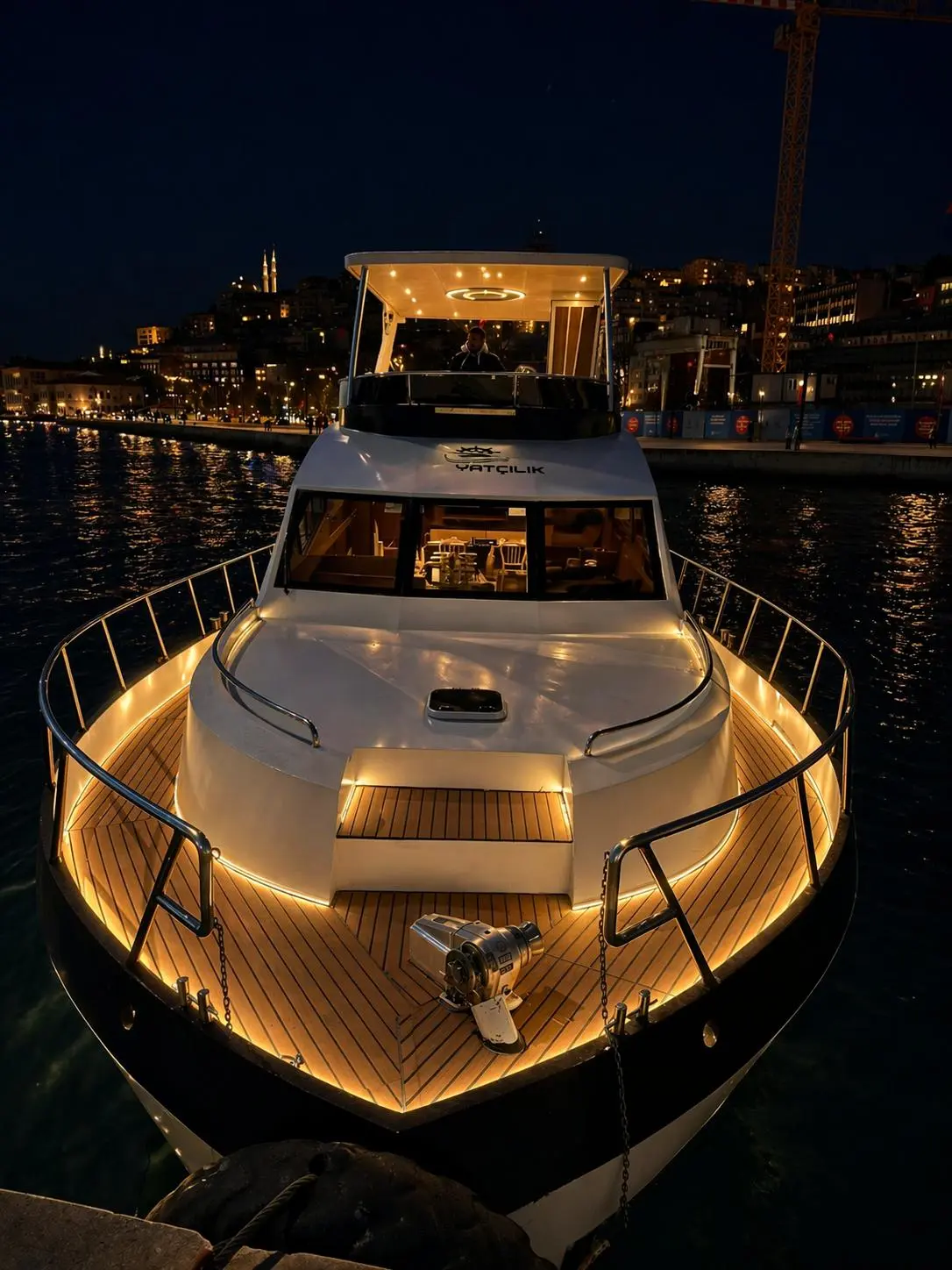 Illuminated front deck of the private yacht at night